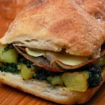 panino ripieno con mortadella, carciofini, rucola e stracchino.